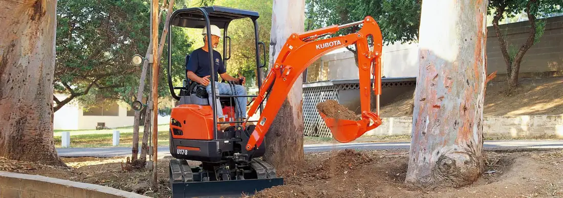 Kubota U17-3 compact excavator working in a confined residential area
